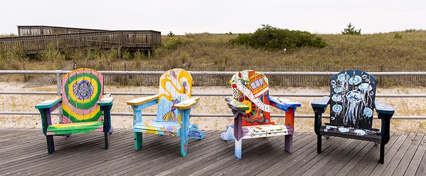 Adirondack chairs painted by four Ospreys