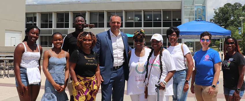 Students, staff, and community members posing for a picture.