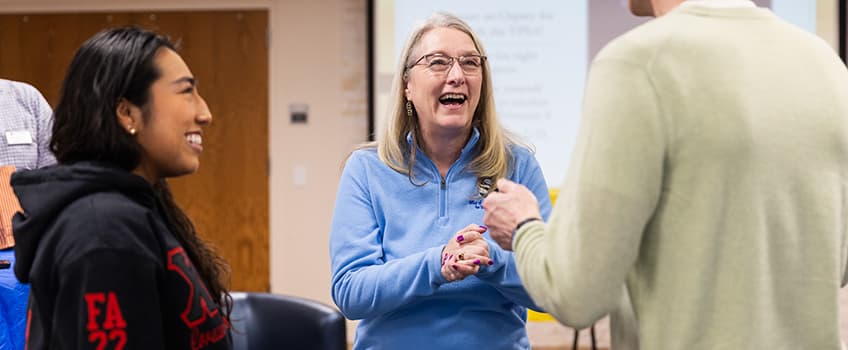 Vice President of Student Affairs, Martha Wygmans, with students. 