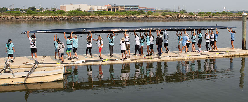 youth rowing carrying