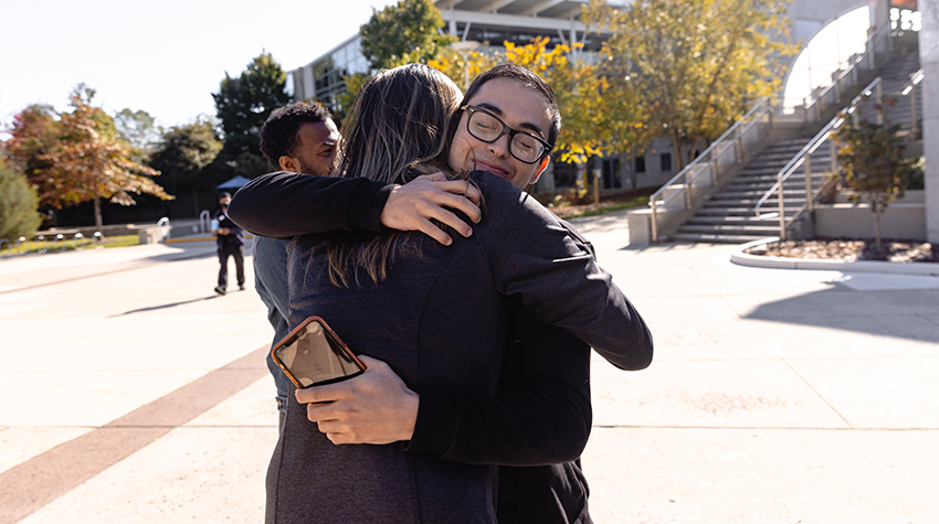 Andrew Simoes shares a moment with Candace Mitchell, director of Student Transition Programs