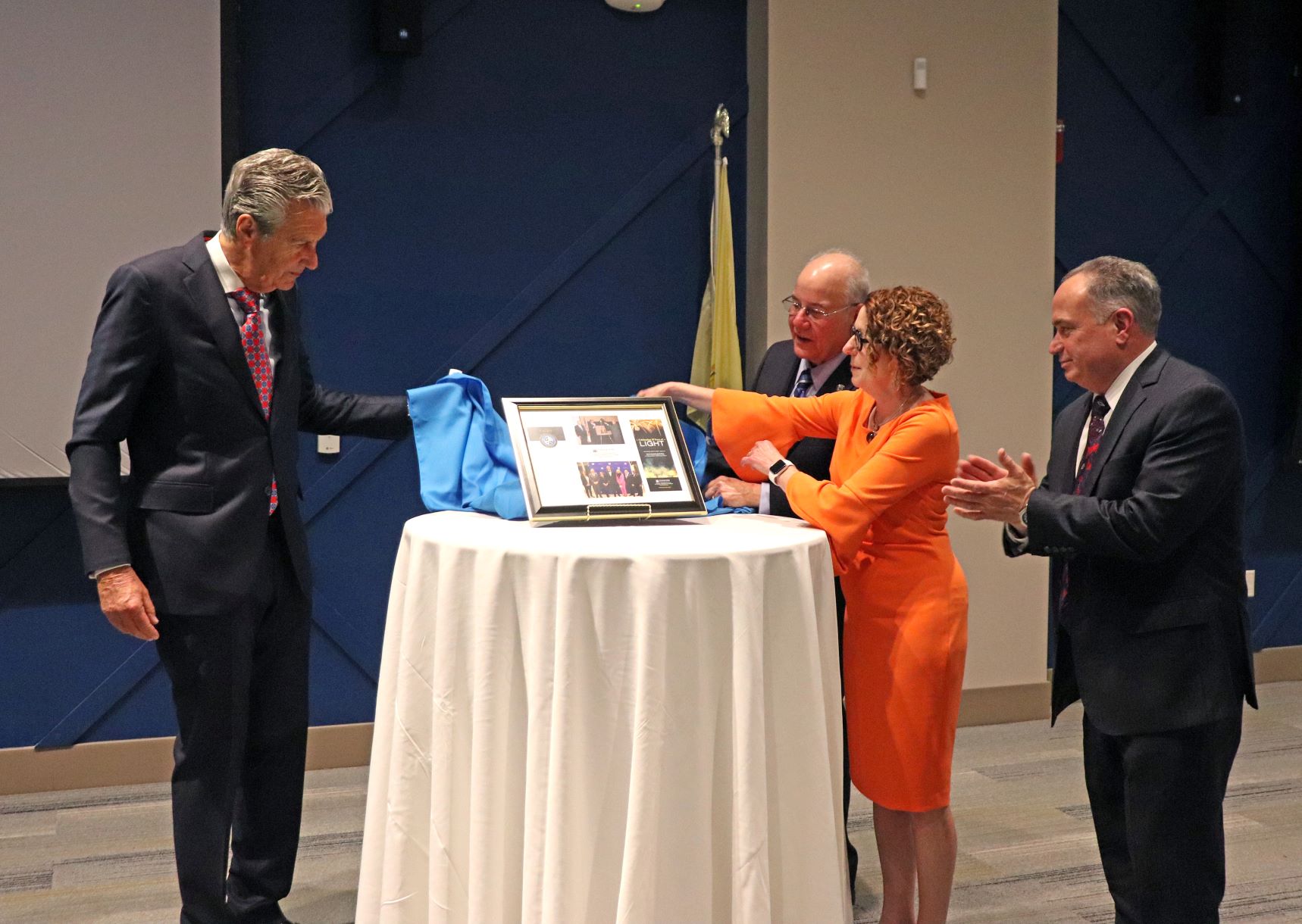 Lloyd D. Levenson is presented with a plaque to recognize his significant contributions to Stockton University and the community.