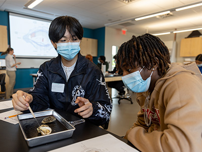 High school students examining the anatomy of an oyster