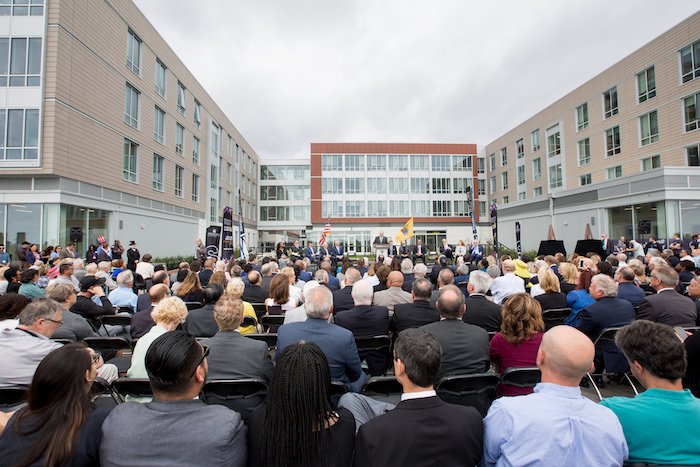 President Harvey Kesselman at ribbon-cutting steps from the beach and ocean.