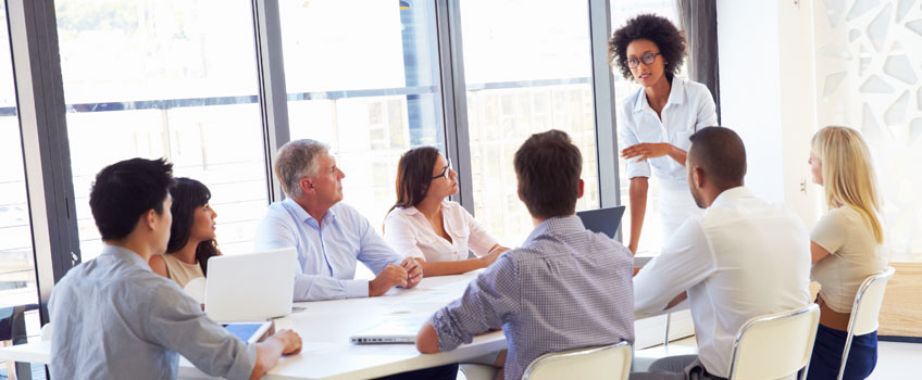 Businesswoman presenting to colleagues at a meeting