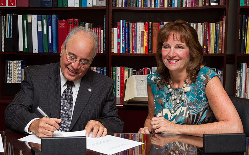 Harvey and Lynne Kesselman signing scholarship agreement