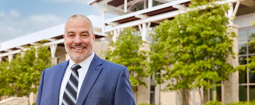 Dr. Joe Bertolino in front of the Campus Center