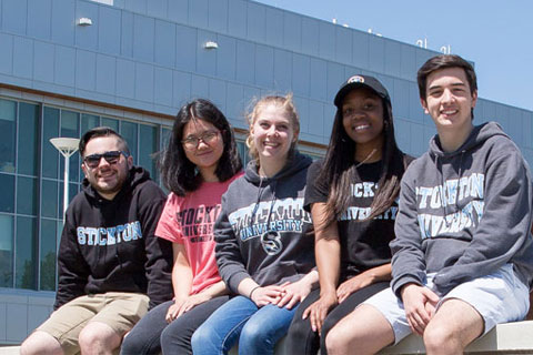 students sitting in the Academic Quad