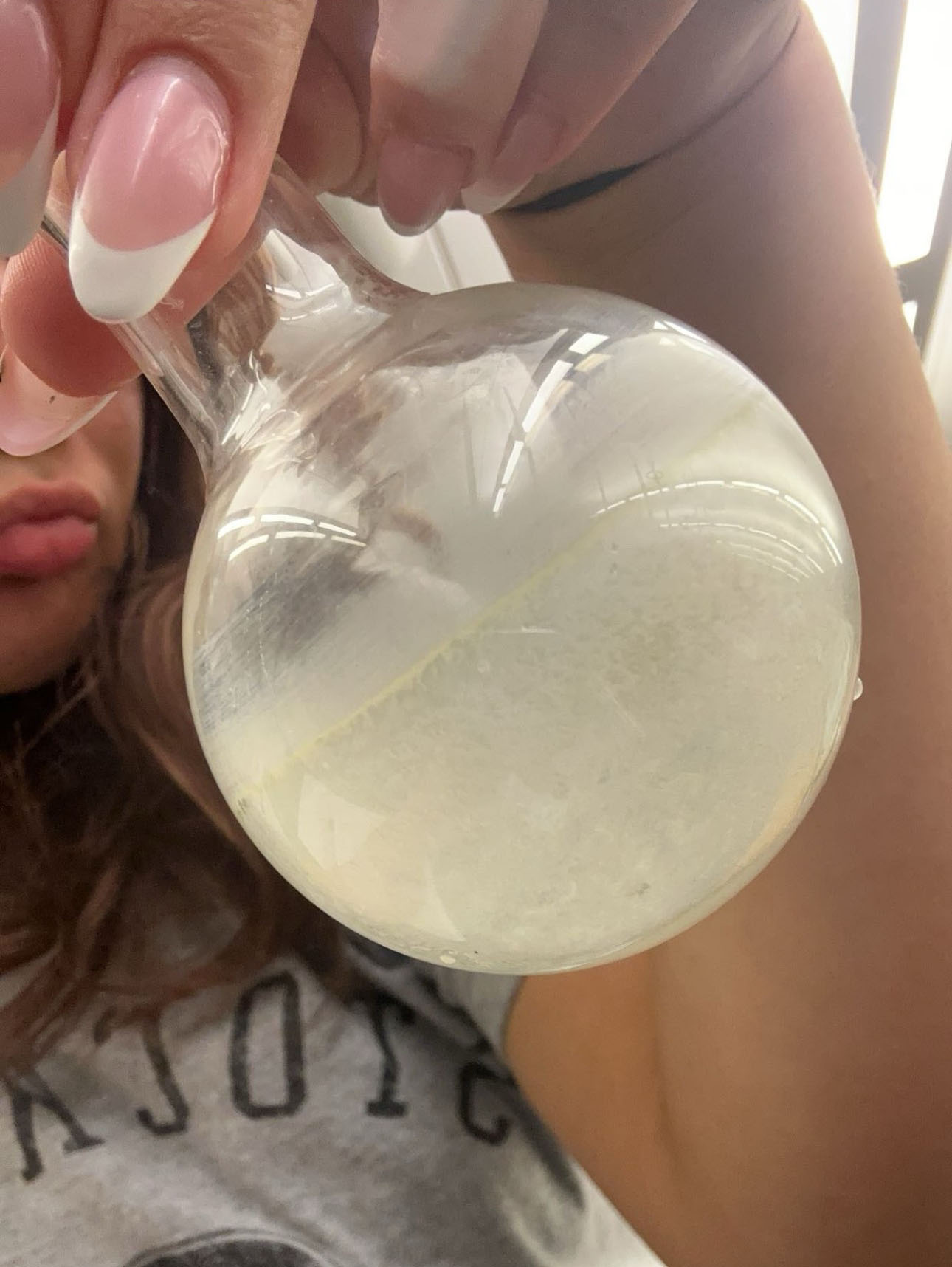 Fontanella holding a flask in the chemistry lab