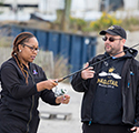 Image of biology professor Dr. Adam Aguiar and local high school student