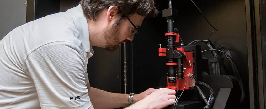 The electron microscope being used by a professor