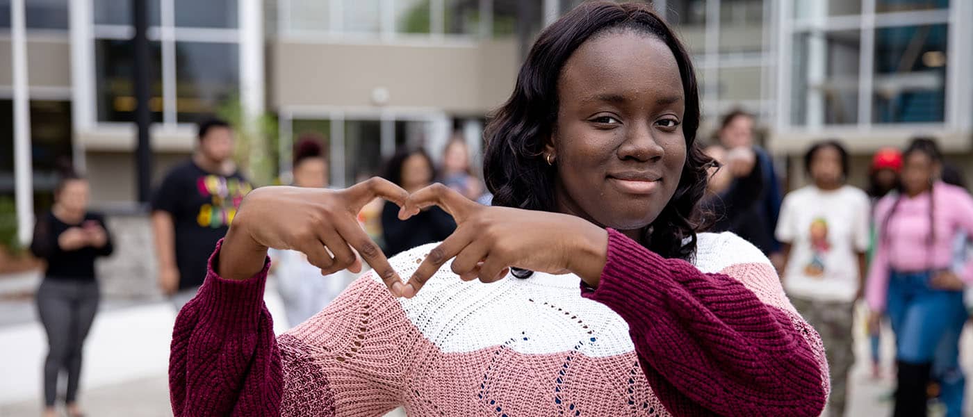 girl making heart