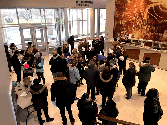 men and women gathering in building lobby