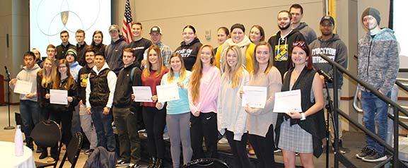 Speaker David Estrin (top row, fifth from left) and students who participated in the opening program on "Together We Remember"