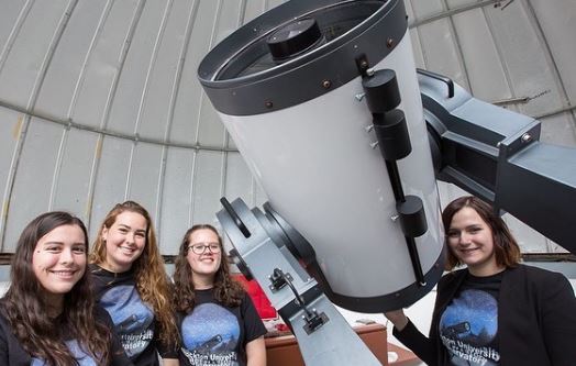 four female students with telescope 