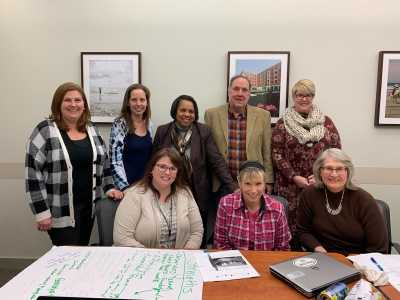 Standing from left to right, Megan Foti, Christine Ferri, Patricia Collins, David Burdick and Jennifer Dunkle. Seated from left to right, Gina Maguire, Christine Gayda-Chelder and Lisa Cox. 