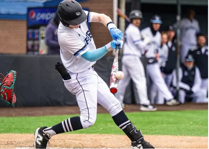 baseball player hits ball