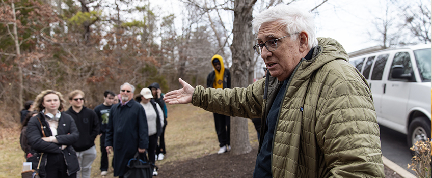 man speaking to tour goers 