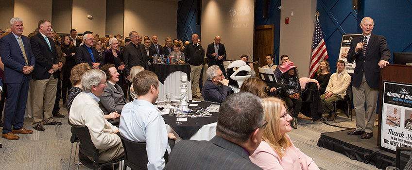 Stan Bergman speaks to a crowd of more than 200 who came to honor him at the Rowing and Growing event