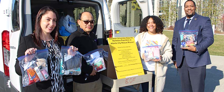 Calli Votta, left, with Tomas Itaas, Damaris Kauffman, and Brett Pulliam load the care packages for the Rescue Mission