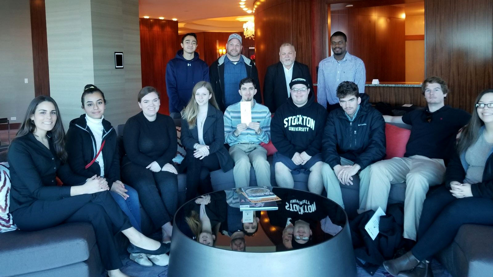 group of students sitting and standing in room