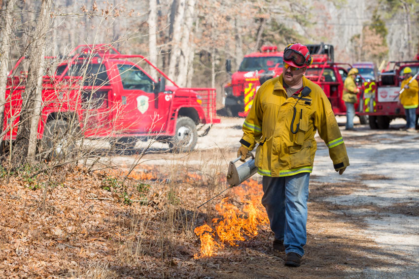 man wakjing near fire outside