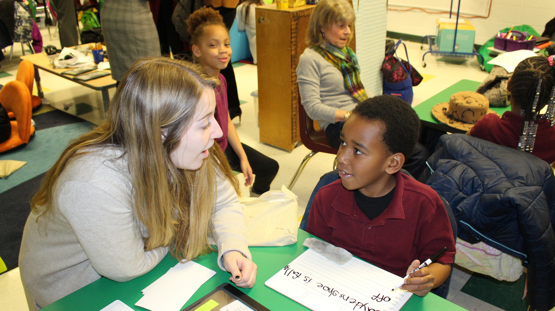 female student tutoring a young male student