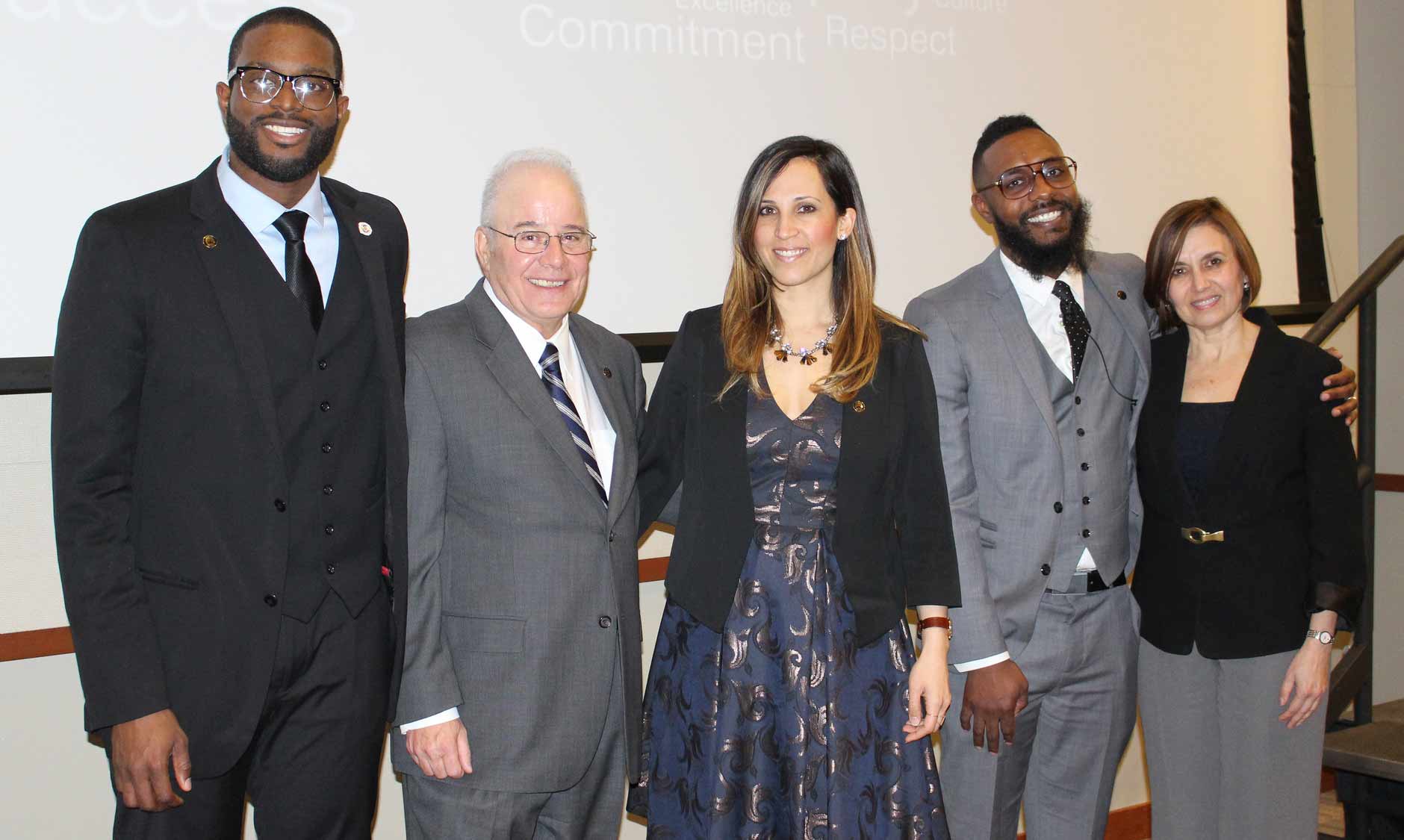 Ike Ejikeme, Harvey Kesselman, Diana Gonzalez, Ryan Terrell and Nelida Valentin at the Diversity Dinner. Below, students featured in a Stockton video share their stories.