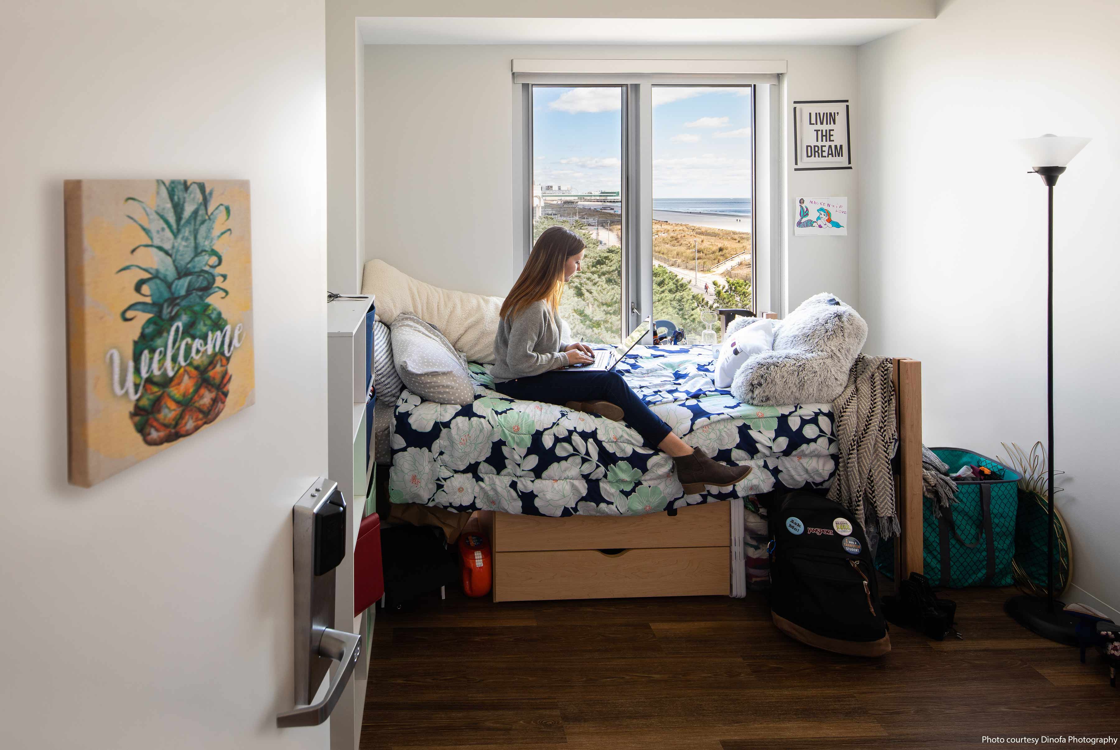 girl sitting on bed in dorm room