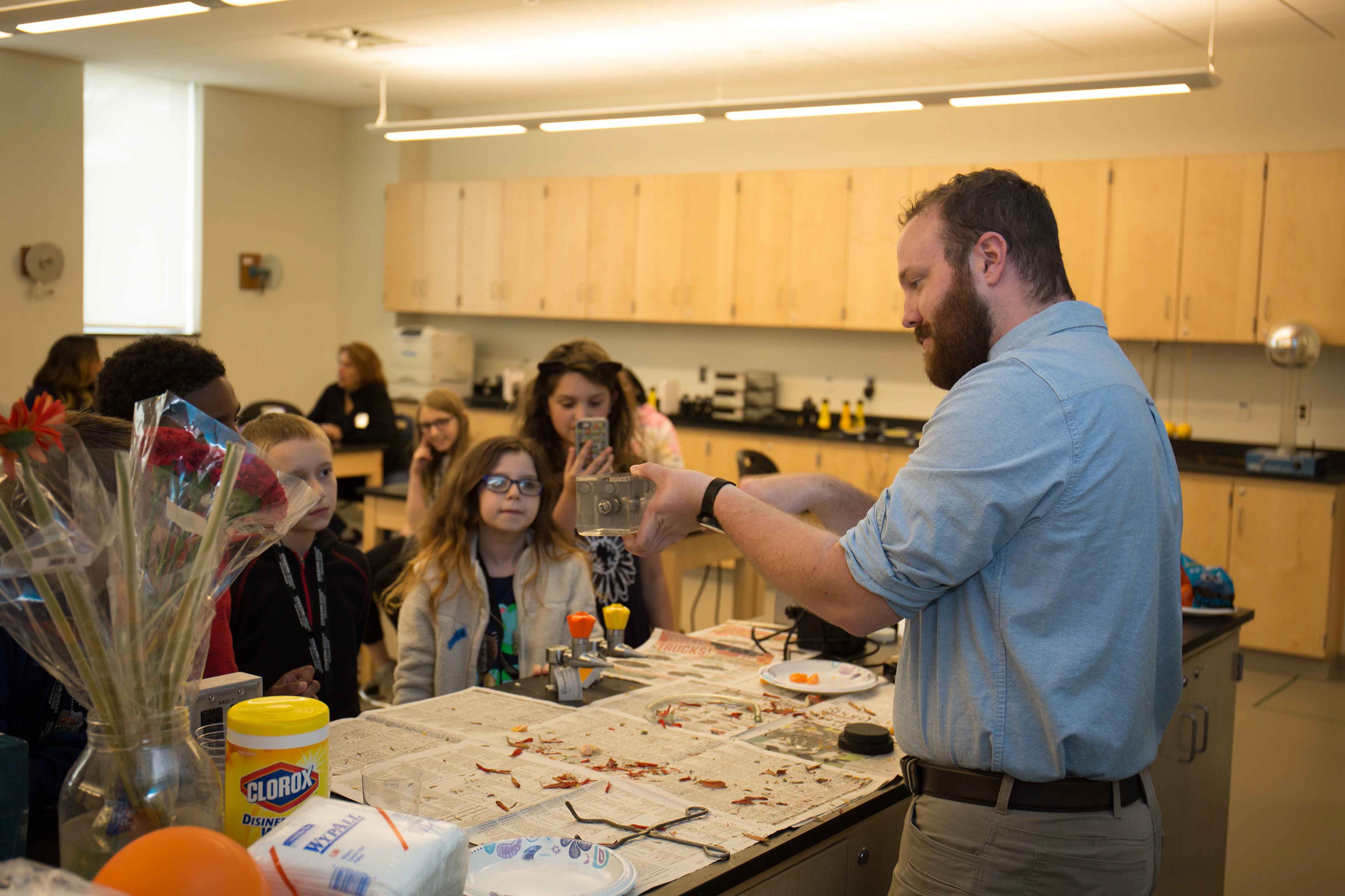 man demonstrating science for children 