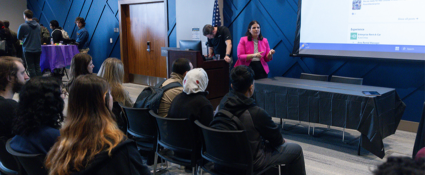woman speaking to students