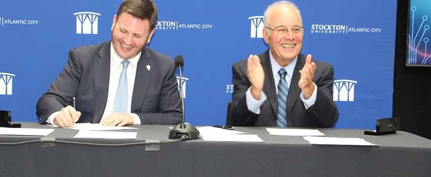 NJEDA Chief Economic Growth Officer Brian Sabina and Stockton President Harvey Kesselman sign the Memorandum of Understanding to create the Esports Innovation Center at the Stockton Atlantic City campus.