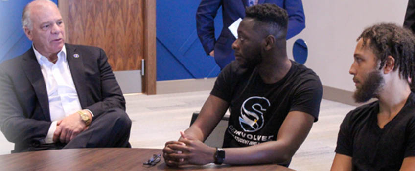 Senate President Steve Sweeney, left , speaks with Stockton students Andy Prempah and Christian Cabrera about the Educational Opportunity Fund and Tuition Aid Grant programs offered by the state.