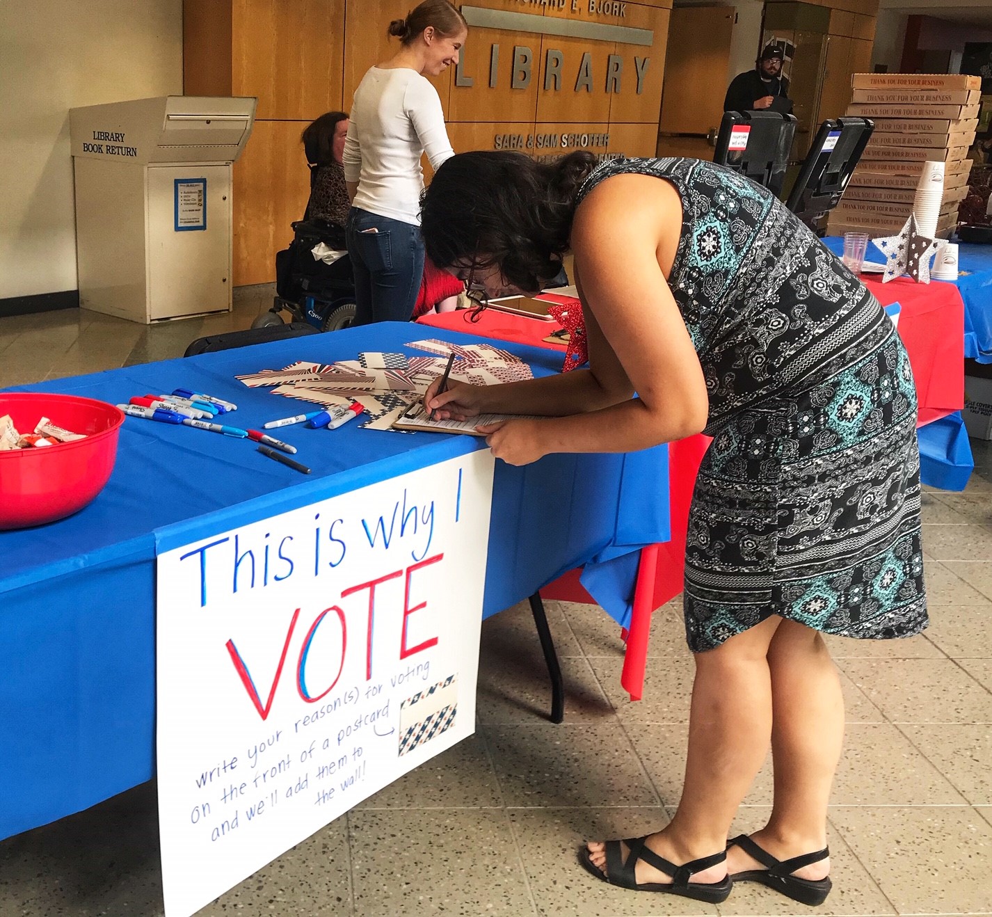 student signing voting form