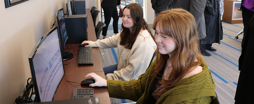 Stockton University seniors Emma Desiderio, left, and Jillian Frantz work on computers