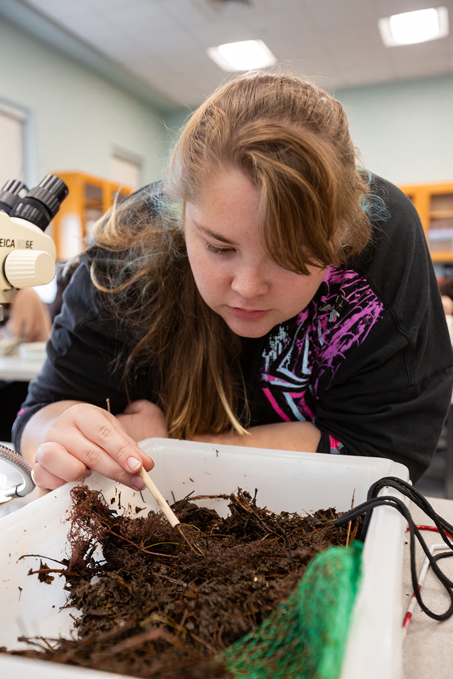 girl looking at dirt