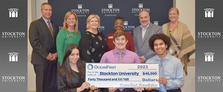 Students holding check