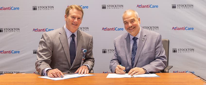 Michael Charlton, President and CEO of AtlantiCare, and President Joe Bertolino at signing.
