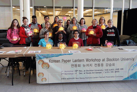 group of men and women displaying lantersn on table