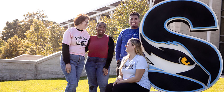 Students infront of S sculpture 