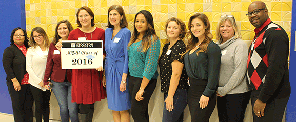 Students from different graduating classes gathered for photos with Professor Diane Falk (in blue dress), founder of the program.