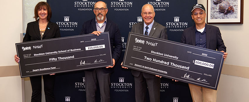 From left: Donna Buzby, chair of the Stockton University Foundation; Steven Silverstein, CEO of Spencer's and Spirit Halloween; Harvey Kesselman, president of Stockton; and Isaac Silvera, president and COO of Spencer's and Spirit Halloween.