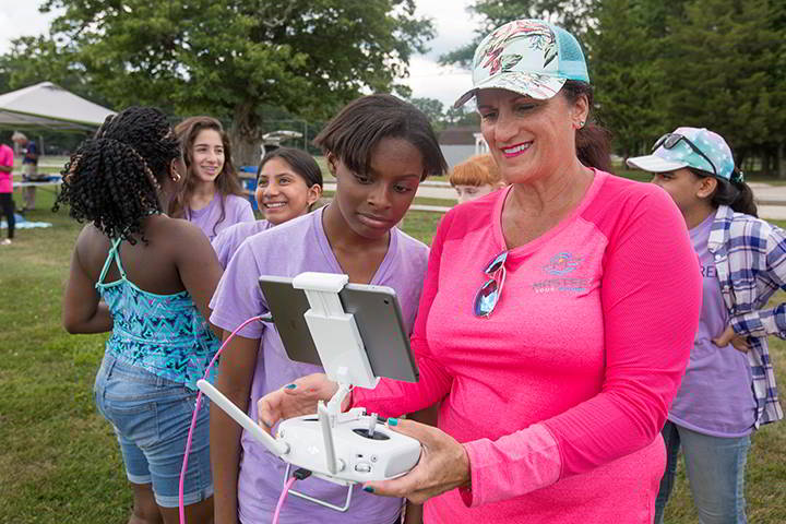 FAA-certified drone pilot Kim Players, who is known as the First Lady of Drones, prepares a camper for her first flight at Stockton’s AAUW Tech Trek Camp.