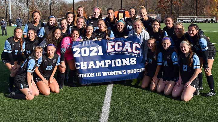 Women's soccer team with championship banner