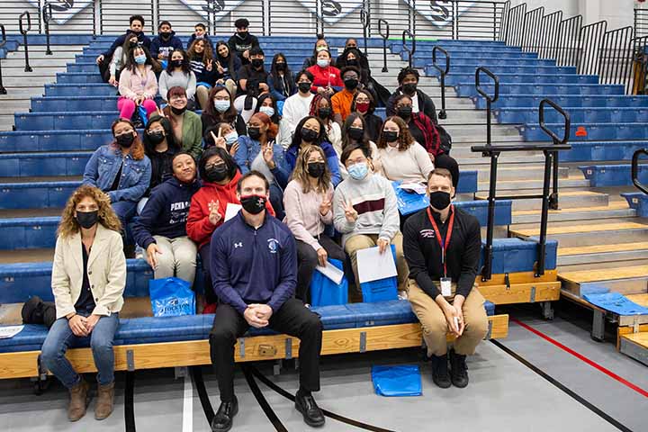 Group of students sitting on bleachers