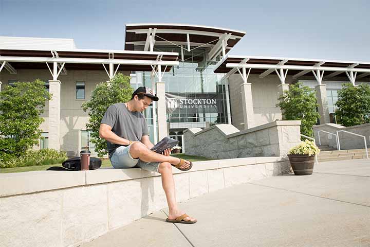 A student studies outside the Campus Center