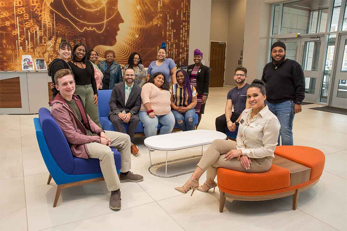 A group of students in administrators in the lobby of the John F. Scarpa Academic Building in Atlantic City