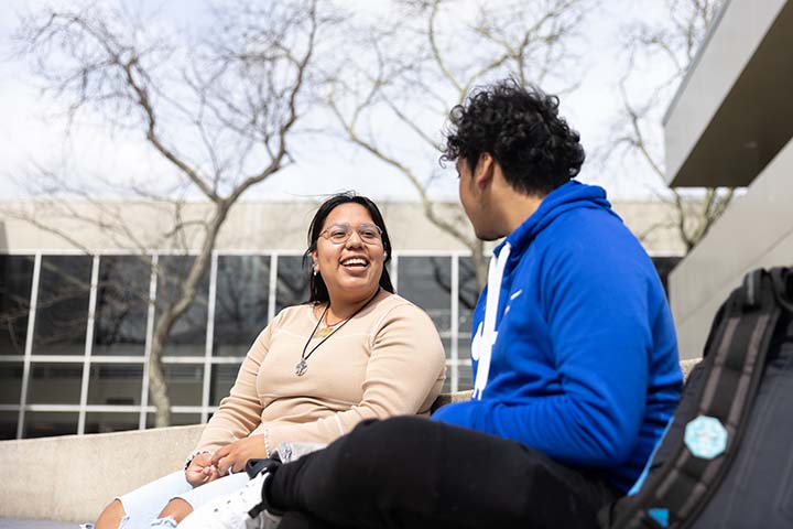 A student chats with a friend outside C wing