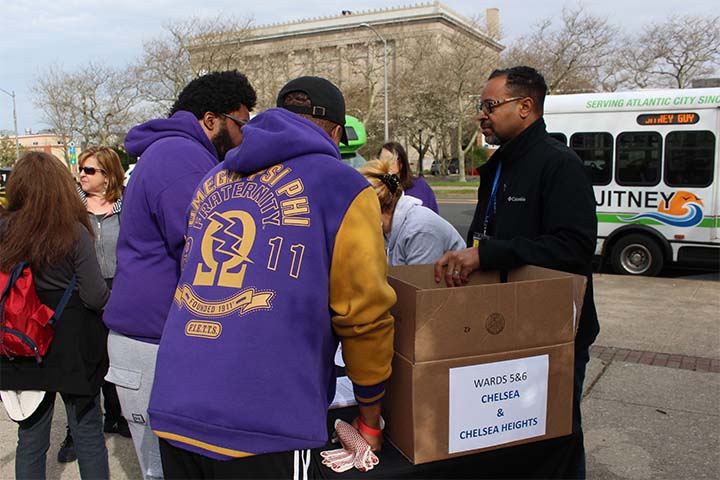 Volunteers help Brian Jackson pack supplies for one of the area cleanups