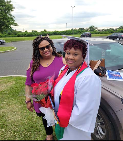 Michelle-Anne Spring and Damaris Spring, who is wearing a silver graduation cap and gown